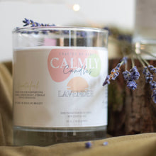 Load image into Gallery viewer, Lavender 100% essential oil, vegan soy wax candle with 100% cotton wick in large, 30cl size. On green velvet fabric, with lavender sprigs and tree slices in backboard.